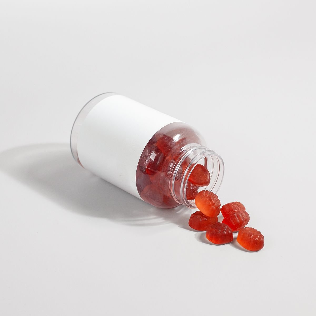 Supplement gummies tipped out of a jar, similar to the IronPulseX format